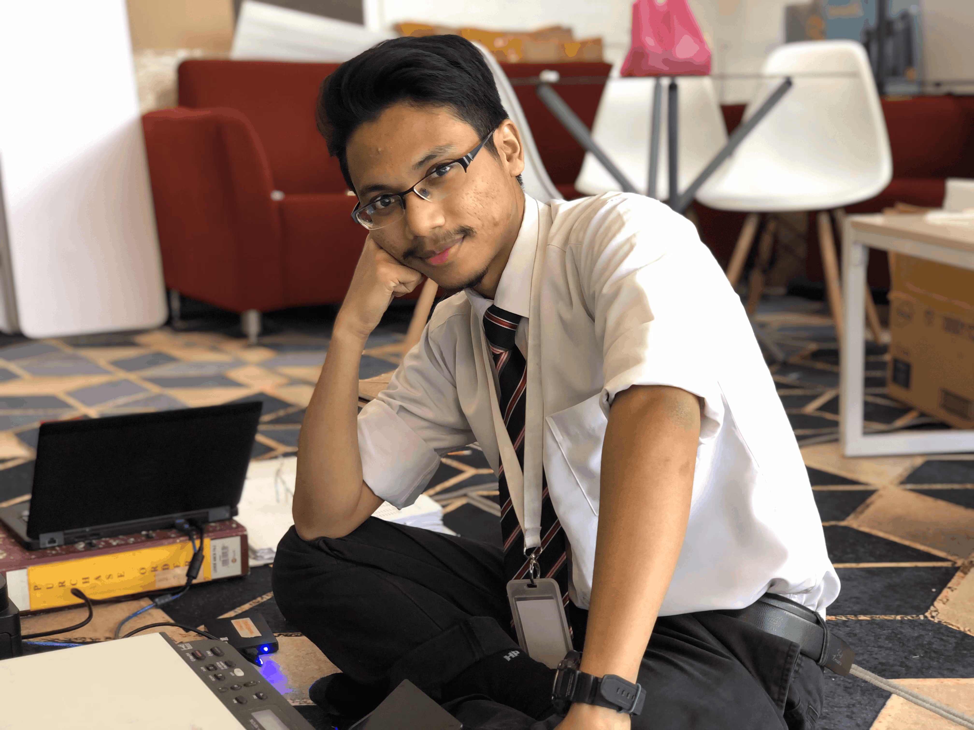 Arif Husaini, founder of Webiscopic, standing in a navy suit